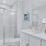 Model bathroom at our townhomes for rent in Waldorf, MD, featuring a shower with glass doors and tiled walls.