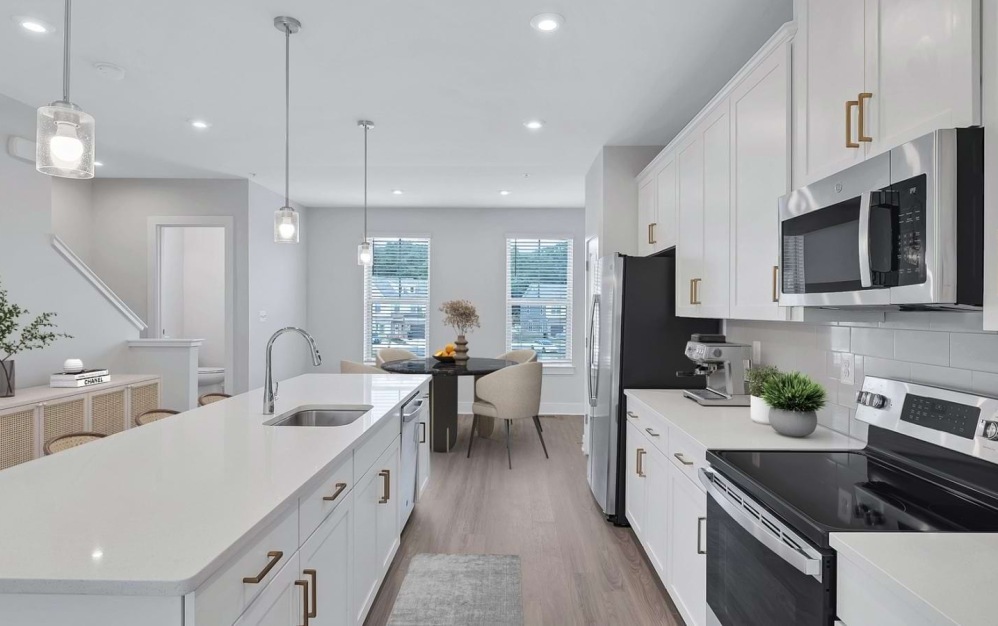 Explore the Hartland at Brookestone in Waldorf, MD: a 2,200 sq. ft. townhome for rent with 3 bedrooms, 2.5 baths, a modern kitchen, and an attached garage.